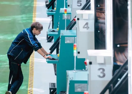 An operator at the control panel of a cubic HPHT press